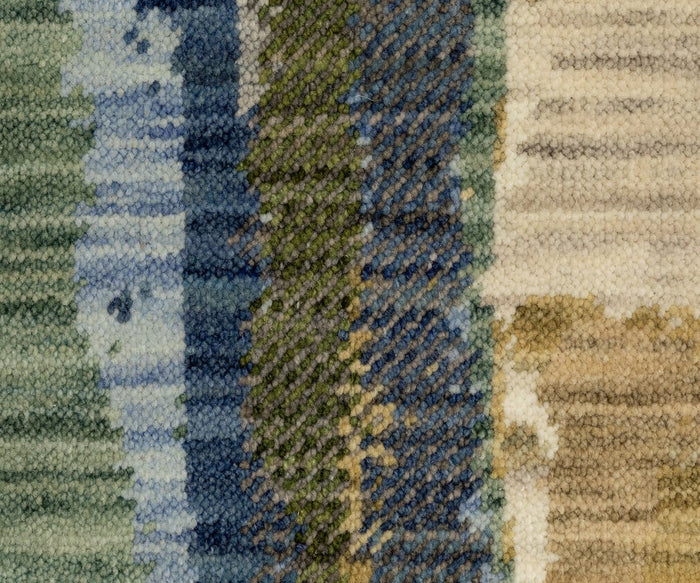 Close-up of the Oriental Weavers Soleri / SOL05 rug, featuring a textured woven fabric with an abstract pattern of vertical, uneven stripes in shades of blue, green, beige, and cream. The visible yarn and soft, fuzzy appearance evoke the luxurious feel characteristic of Axminster-style rugs.