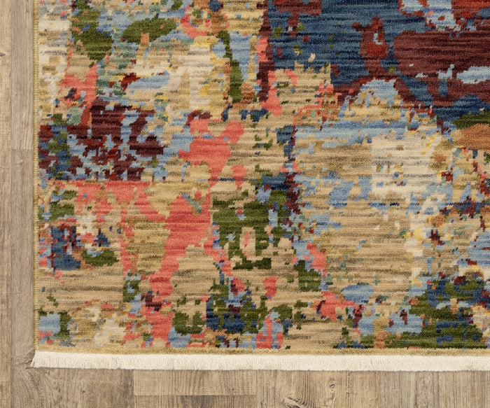 A corner of the Oriental Weavers Soleri / SOL06 Rug, showcasing its colorful abstract pattern in shades of red, blue, green, and beige on a wood floor; this modern rug features a white fringe edge and is expertly crafted from a wool and nylon blend using an Axminster loom.