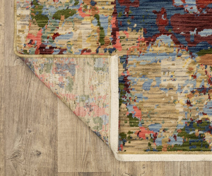 A corner of the Oriental Weavers Soleri / SOL06 Rug is folded over, revealing the underside, on a light wood floor. Crafted from a blend of wool and nylon, this modern abstract rug showcases splashes of blue, red, yellow, and green tones.