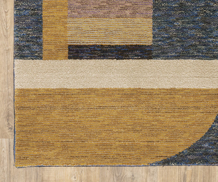 The Oriental Weavers Strada / STR01 Rug, showcasing a contemporary Art Deco-inspired design with geometric shapes in mustard yellow, cream, brown, and blue, rests on a light wood floor. Its pattern features bold stripes and blocks that create a modern abstract aesthetic.