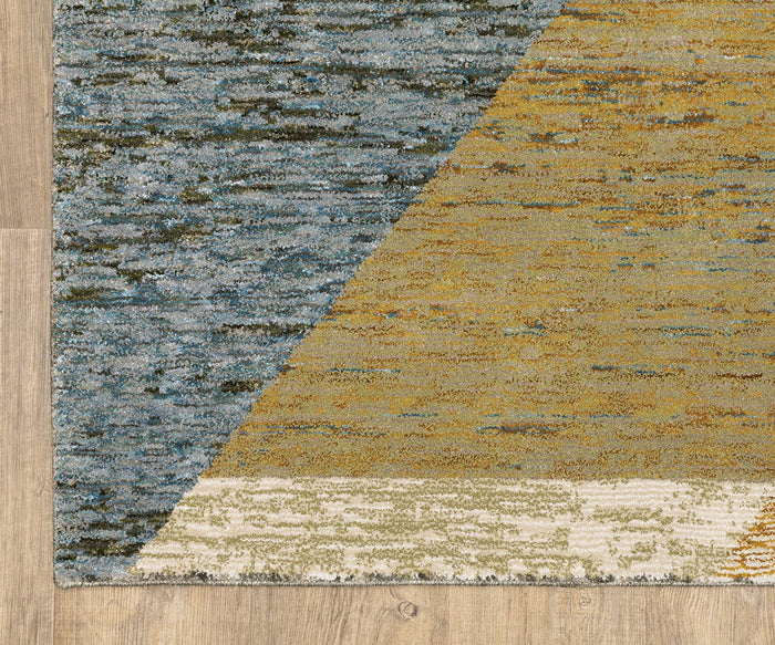 A close-up of the Oriental Weavers Strada / STR09 Rug—a machine-woven nylon area rug—displaying its soft, textured surface and abstract blue, yellow, and off-white color transitions on a light wood floor.
