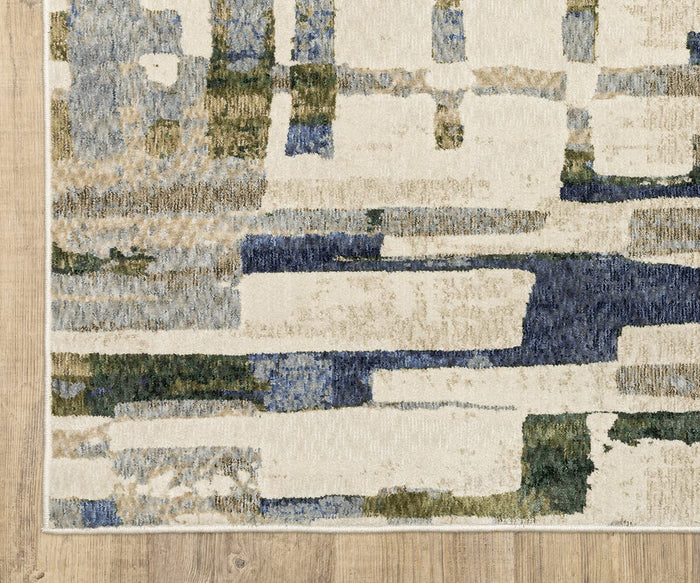 The Oriental Weavers Tisdell / TIS01 Rug features abstract rectangular and linear patterns in vibrant jewel tones of blue, green, beige, and cream. Crafted from durable polyester, this area rug is showcased on a light wood floor.
