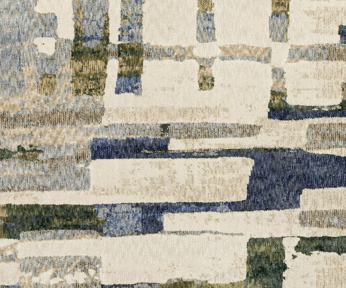 The Oriental Weavers Tisdell / TIS01 Rug showcases overlapping rectangular shapes in beige, blue, and green tones, creating a modern and textured look. Its abstract painterly design features softly layered edges for an artful effect throughout. Crafted from durable polyester, this area rug brings contemporary style and lasting appeal to any space.