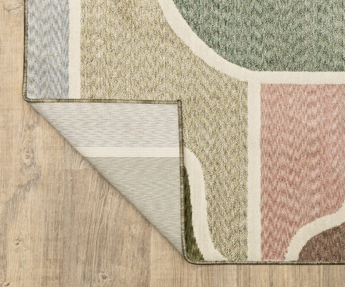 A close-up of a corner of the Oriental Weavers Tisdell / TIS02 Rug, with one edge flipped over to reveal its underside on a wooden floor—an ideal example of space-dyed polyester rugs that blend bold color with lasting durability.