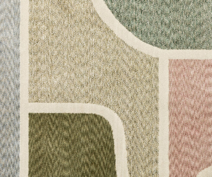 The Oriental Weavers Tisdell / TIS02 Rug showcases an abstract pattern with curved and straight lines, incorporating sections of green, beige, gray, and pink tones outlined by light cream borders. Crafted from space-dyed polyester for enhanced vibrancy and resilience, this modern rug offers a soft, slightly fuzzy texture while providing durable performance for everyday use.