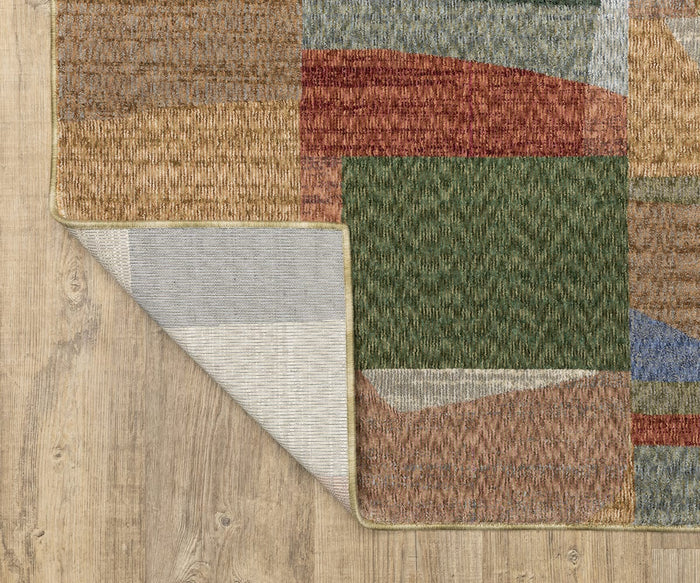 The Oriental Weavers Tisdell / TIS09 Rug, featuring a multicolored geometric design in earth tones and crafted from space-dyed polyester for enhanced vibrancy, is partially flipped to reveal its underside and displayed on light wood flooring.