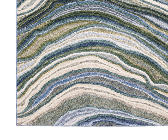 Introducing the Oriental Weavers Tisdell / TIS10 Rug, featuring wavy, layered patterns in shades of blue, green, cream, and beige reminiscent of natural mineral or geode formations. Crafted from space-dyed polyester to enhance texture and depth, this modern abstract rug is both visually striking and exceptionally durable—making it an ideal choice for high-traffic areas.