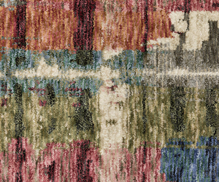 A close-up of the Oriental Weavers Tisdell / TIS12 Rug shows its textured, multicolored surface featuring abstract patterns in shades of red, green, blue, beige, and gray. Crafted from space-dyed polyester fibers for long-lasting quality, this modern rug offers soft fibers and a unique non-representational design—perfect for adding vibrant color and character to any space.