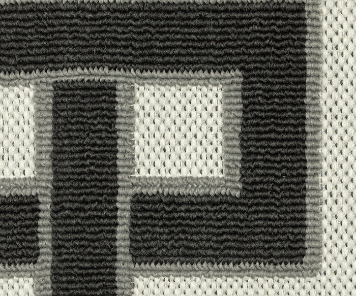 Close-up of the Oriental Weavers Torrey / 1530I Rug showcasing a black and gray geometric pattern with abstract motifs on textured, woven fabric featuring dynamic texture, visible stitching, and a white background; part of the distinctive Torrey Collection.