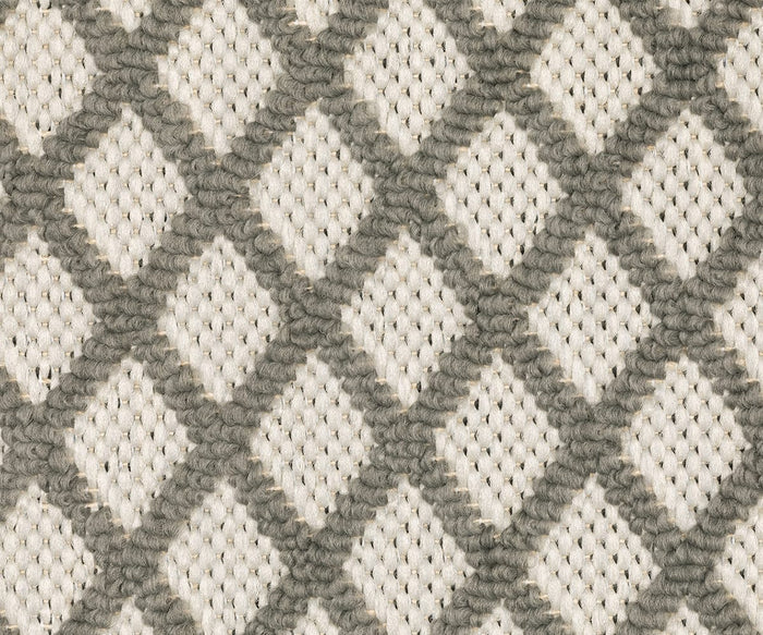 Close-up of the Oriental Weavers Torrey / 501H1 Rug, showcasing its textured fabric with a diamond lattice pattern in neutral gray and beige tones. Gray lines form abstract, interconnected diamond motifs across a soft beige background.