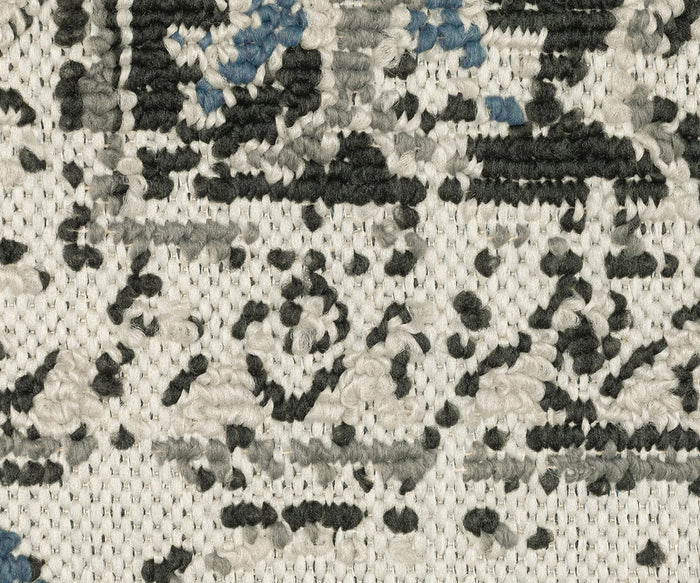 Close-up of the Oriental Weavers Torrey / 5561H Rug, highlighting its intricate, traditional pattern in shades of cream, charcoal gray, and dusty blue accents. The textured looped pile fabric beautifully showcases the detailed abstract motifs throughout this striking piece from the Torrey Collection.