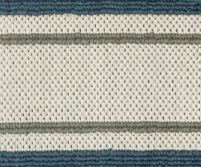 Close-up of the Oriental Weavers Torrey / 5571Y Rug, featuring a woven fabric with a cream-colored background and alternating horizontal stripes in light gray and blue. The dynamic texture appears thick and slightly raised.