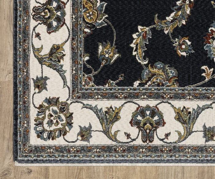 Corner of the Oriental Weavers Vivian / VI01B Rug featuring a floral design in cream, dark blue, green, and gold on a wooden floor. Reminiscent of traditional area rugs and Persian-inspired styles, this rug showcases a decorative border and intricate detailing.