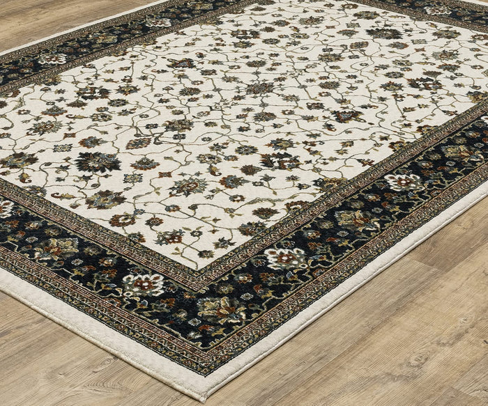 The Oriental Weavers Vivian / VI02B Rug, crafted from soft microfiber polyester, features a cream center adorned with floral and vine motifs and a dark intricate border—evoking the elegance of Persian-inspired rugs with its traditional color palette, and looks beautiful placed on light wood flooring.