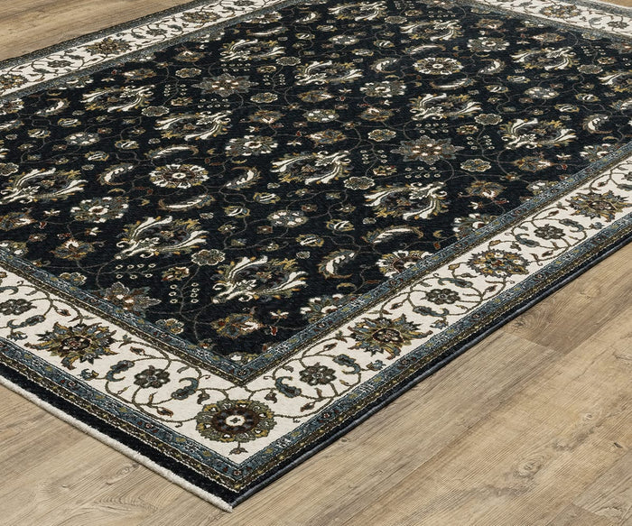 The Oriental Weavers Vivian VI03A Rug features an ornate floral pattern in rich, dark hues, framed by a wide cream border with additional floral detailing. Inspired by traditional Persian rugs, this rectangular piece showcases a classic color palette and is displayed on a light wooden floor.