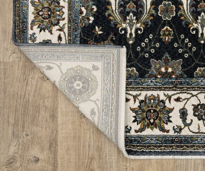 A corner of the Oriental Weavers Vivian / VI03A Rug is folded over on a wooden floor, exposing the lighter, muted backside and highlighting the detailed, colorful floral pattern on the front—showcasing its Persian-inspired design and traditional color palette.