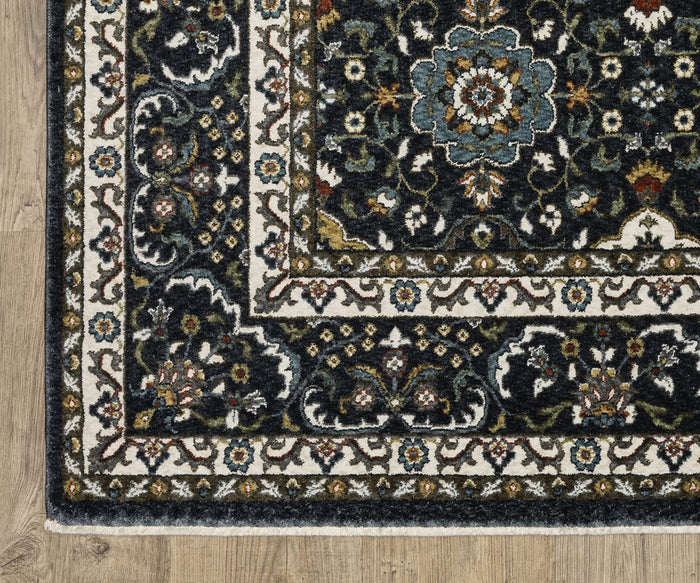 Corner of the Oriental Weavers Vivian / VI04C Rug, showcasing a Persian-inspired floral pattern in blue, cream, and gold tones atop a wooden floor. Expertly crafted from soft microfiber polyester, this rug features intricate borders and detailed motifs.