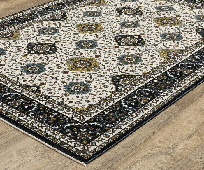The Oriental Weavers Vivian / VI04D Rug features a cream background adorned with blue and gold floral medallions and a dark ornate border, displayed here on a light wood floor. Persian-inspired, this rug’s traditional color palette lends timeless elegance to any space.