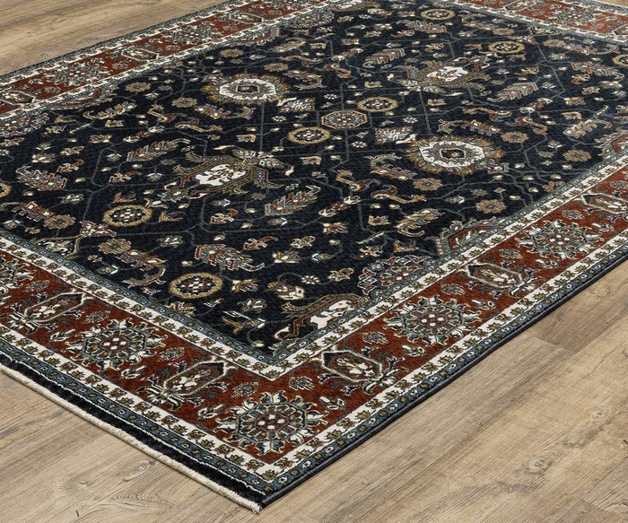 The Oriental Weavers Vivian / VI05A Rug features a rectangular shape with a dark blue center adorned with intricate floral and geometric patterns, framed by a wide red border with decorative detailing. Placed on a light wood floor, this rug draws inspiration from traditional Persian designs and showcases a classic color palette.