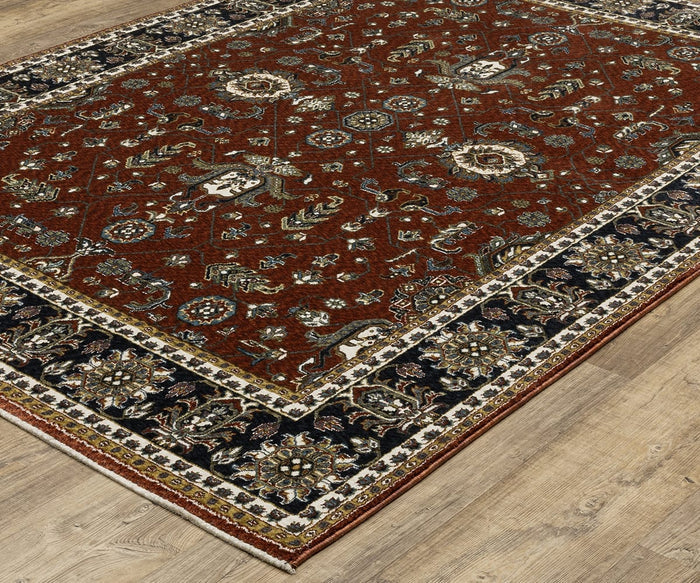 The Oriental Weavers Vivian / VI05X Rug, featuring a red patterned center with intricate floral and geometric motifs and a detailed dark blue border in a classic Persian-inspired color palette, is placed on a light wood floor.