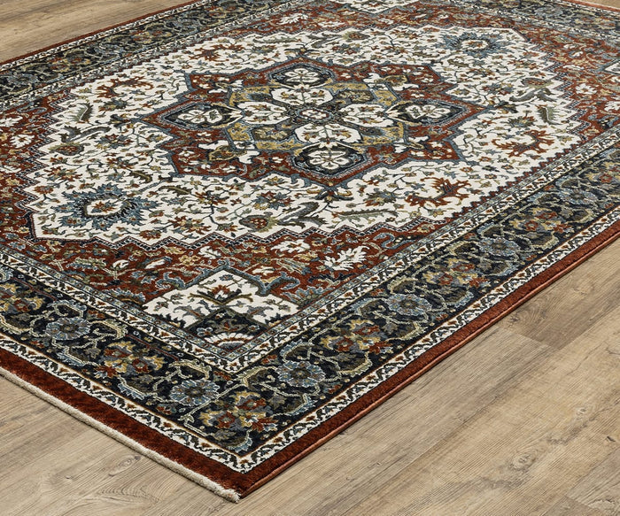 The Oriental Weavers Vivian / VI06A Rug graces a wooden floor with its Persian-inspired design, showcasing a central medallion and intricate floral patterns in rich red, navy, cream, gold, and blue tones. The detailed geometric and floral borders beautifully capture the timeless elegance of traditional palette rugs.