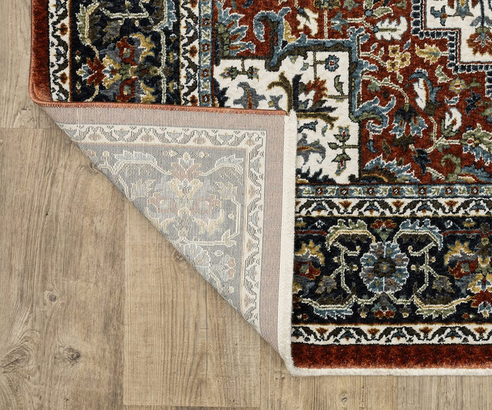 A corner of the Oriental Weavers Vivian / VI06A Rug is flipped over on a wooden floor, revealing its beige underside and intricate, multicolored floral designs in red, blue, black, and white—showcasing the timeless elegance characteristic of Persian-inspired rugs.