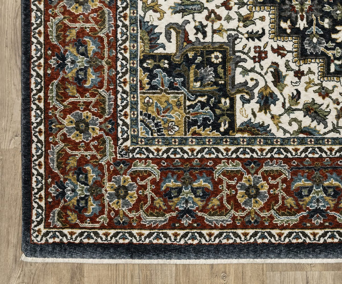 Corner of the Oriental Weavers Vivian / VI06C Rug, showcasing red, blue, yellow, and ivory floral designs on a wooden floor. The border displays intricate detailing with symmetrical floral and geometric motifs that capture the essence of Persian-inspired rugs. Crafted from microfiber polyester, this rug offers timeless style combined with modern durability.