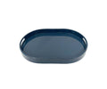 The Oval Lacquer Tray features a dark blue finish in an oval shape, with raised edges and cutout handles on the sides, and is displayed against a white background.