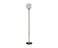 The Patina Floor Lamp features a round, frosted glass lampshade with a subtle fluted pattern, a slim brass pole, a pull chain, and a circular black base.