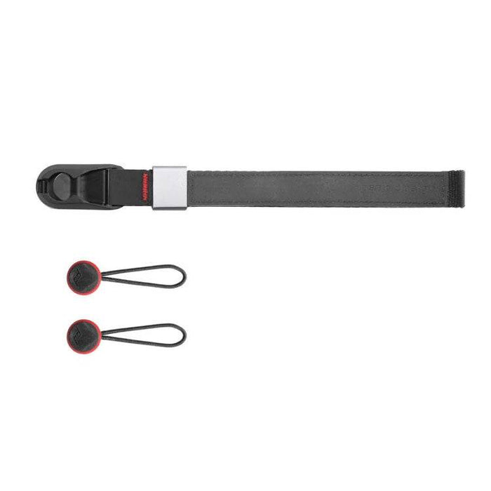 Peak Design Cuff wrist strap attached to a camera, showcasing its low-profile design and aluminum hardware.