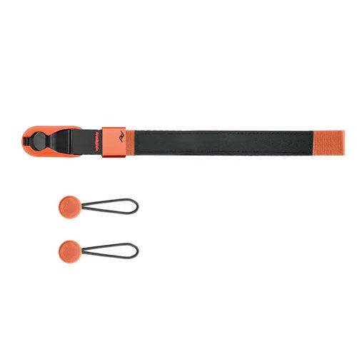 Peak Design Cuff wrist strap attached to a camera, showing aluminum hardware and durable nylon webbing