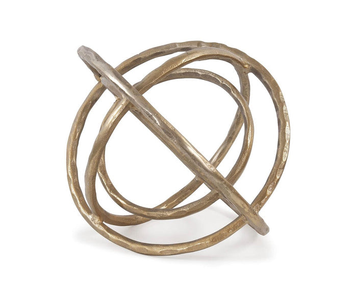 The Planetary Rings Sculpture is a decorative object crafted from intersecting antiqued brass metal rings, forming a spherical, open geometric design and displayed against a white background.