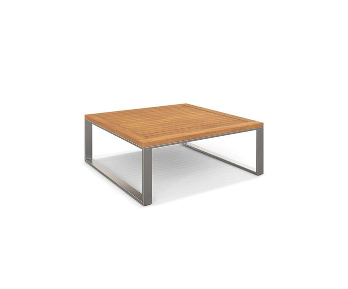 The Playa Mar Outdoor Coffee Table, shown on a white background, features a square teak finish wooden top and metal legs. Part of the Playa Mar Collection, this outdoor coffee table boasts a modern, minimalist design with clean lines and a low profile.