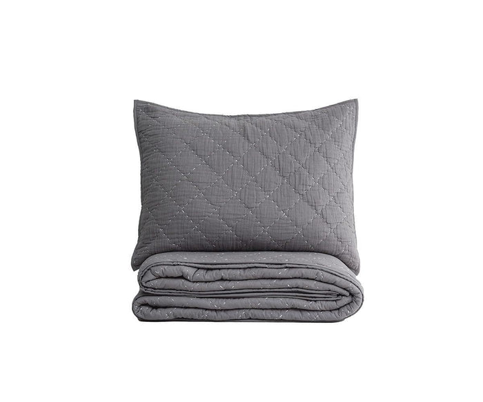The Plush Diamonds Quilt + Sham Set in grey is displayed with the quilt folded and the matching quilted sham propped behind it, both showcasing a subtle plush diamond pattern against a plain white background.