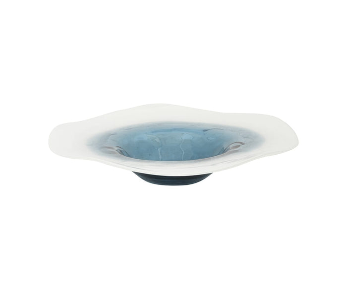 The Polar Frost Bowl is a shallow, wide glass bowl featuring a wavy rim and exquisite hand-finished craftsmanship. Mostly clear with a blue tint radiating from the center and softly fading to white at the edges, this decorative accent adds an elegant touch to any space.