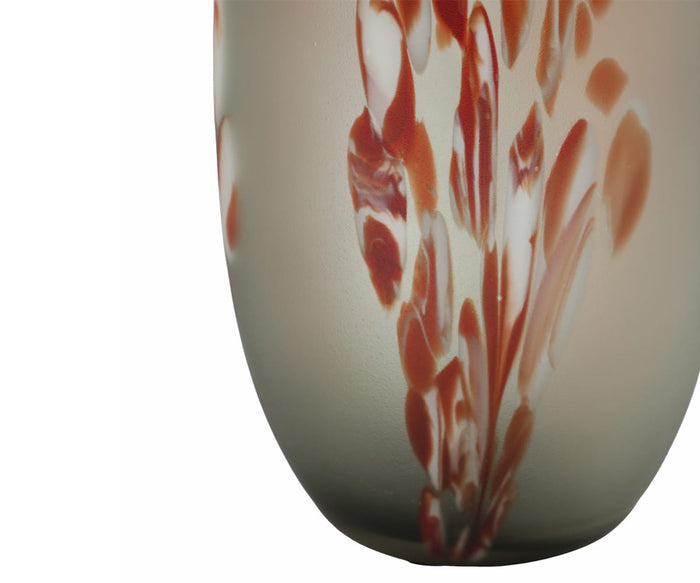 A detailed view of the Poppy Frost Vase, featuring hand-finished glass with abstract red and white brushstroke patterns set against a beige background.