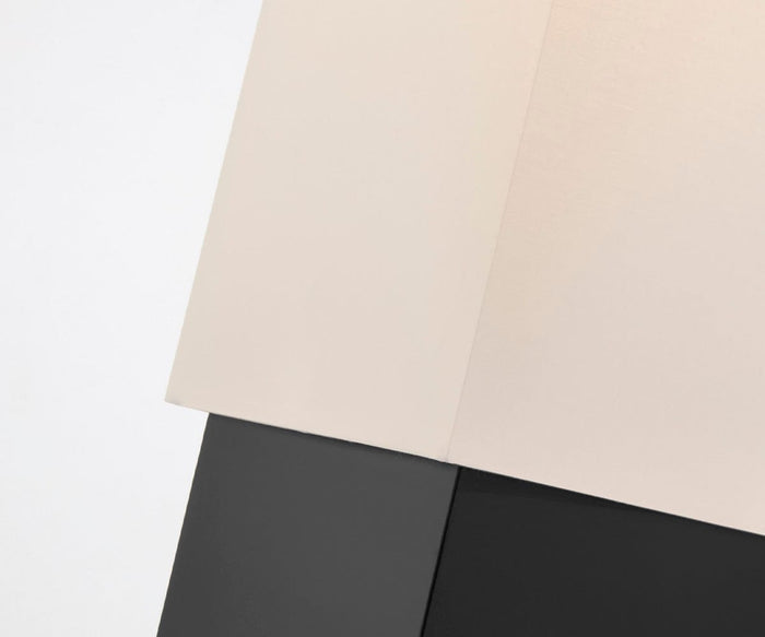 Two overlapping rectangular panels, one light beige and one dark gray, are set against a white background. The image has a minimalist, abstract composition with sharp, clean lines and a modern feel—reminiscent of the sleek silhouette found in the Quinlan Table Lamp.
