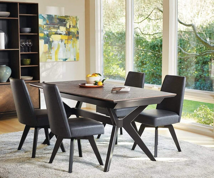 A modern dining room featuring a wooden table, four Raynor Swivel Dining Chairs in dark upholstery, a gray rug, a fruit bowl centerpiece, large windows, and an abstract painting on the wall.