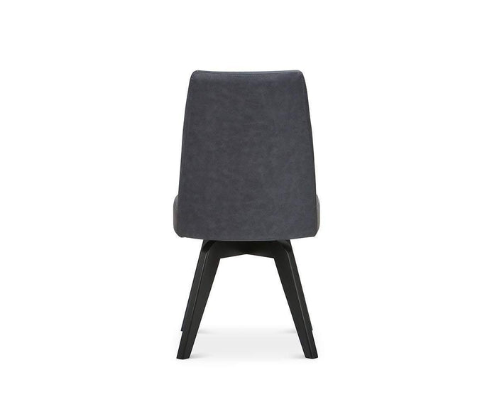 A contemporary Raynor Swivel Dining Chair featuring a dark gray upholstered backrest and black angled legs, displayed from the rear against a white background.