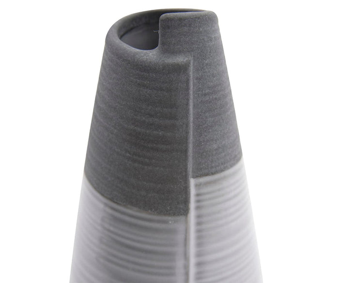 A close-up of the Rolled Two Tone Vase, a textured, cone-shaped gray ceramic piece featuring a vertical groove and a rounded slot near the top—an eye-catching example of modern design.