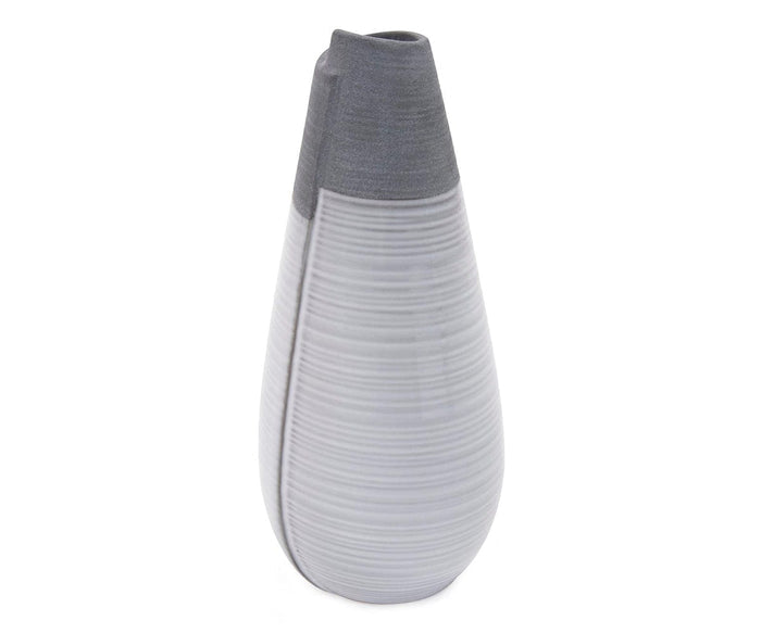 The Rolled Two Tone Vase features a modern, tall ceramic design with a matte gray finish on the upper half and a lighter, horizontally striped pattern on the bottom.