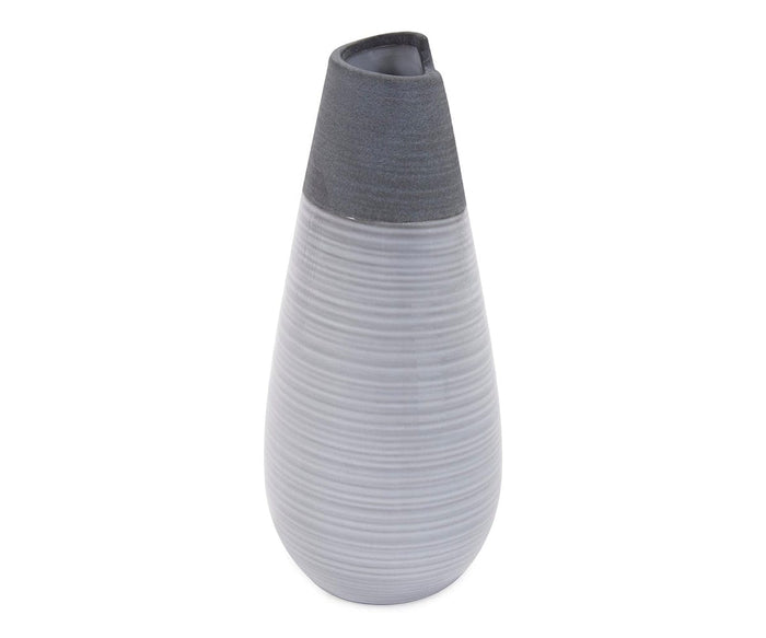 Introducing the Rolled Two Tone Vase: a tall, modern ceramic vase with a matte finish, showcasing a mostly light gray body adorned with subtle horizontal ridges and complemented by a dark gray, angled top opening.