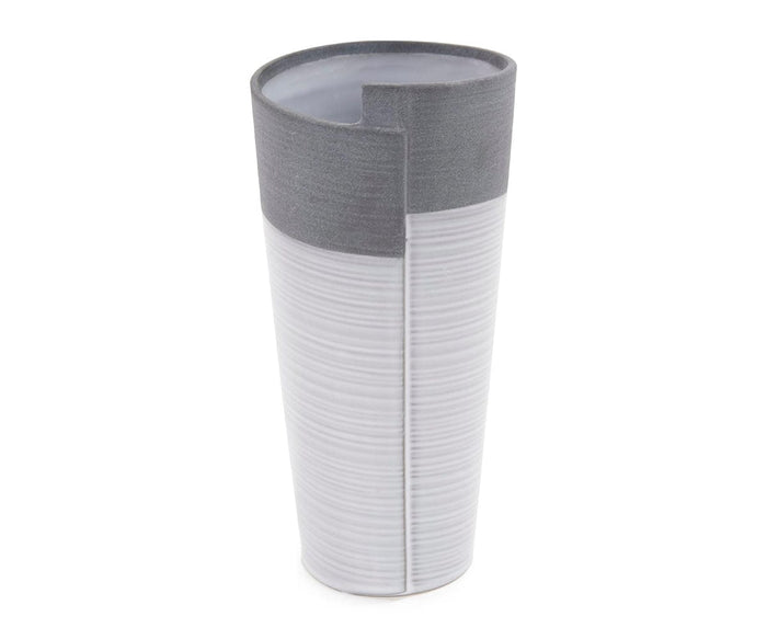 The Rolled Two Tone Vase is a tall, modern ceramic piece in grey, featuring a matte gray top and a textured light gray bottom. Its rim is designed with a small indented notch for added visual interest.