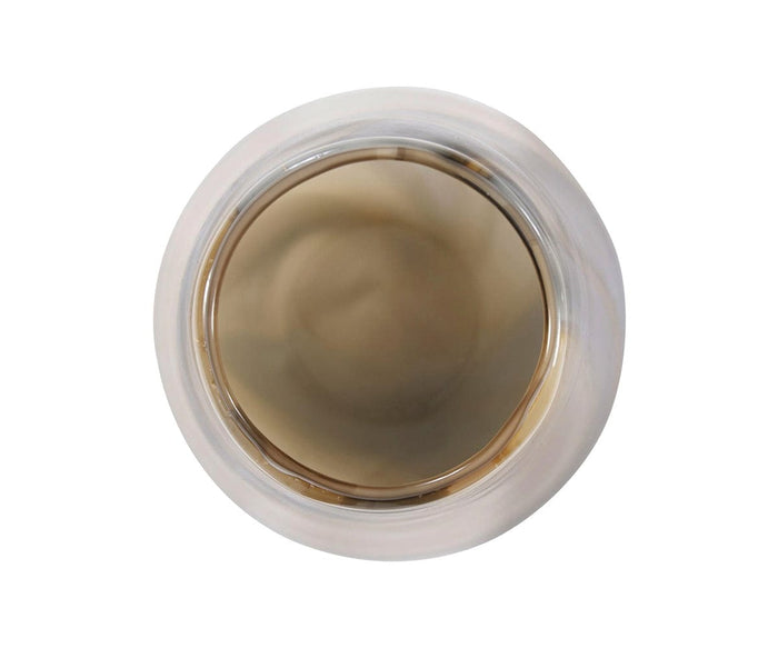 Top view of a cup filled with brown liquid, likely coffee or tea, set against a white background beside a sleek Sand Art Tapered Glass Vase.