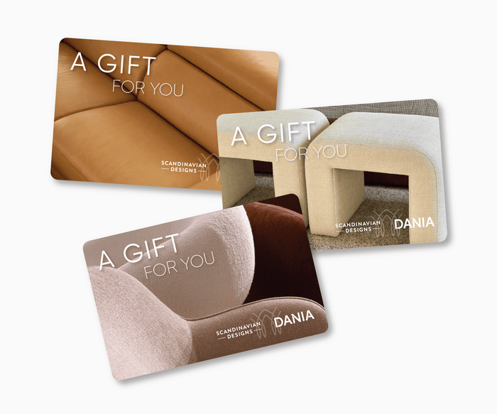 Three Scandinavian Designs Gift Cards, each showcasing close-up images of modern furniture in brown, beige, and tan upholstery. These cards are labeled “A Gift For You” and display the Dania logo, making the Scandinavian Designs Gift Card the perfect home decor gift for any occasion.