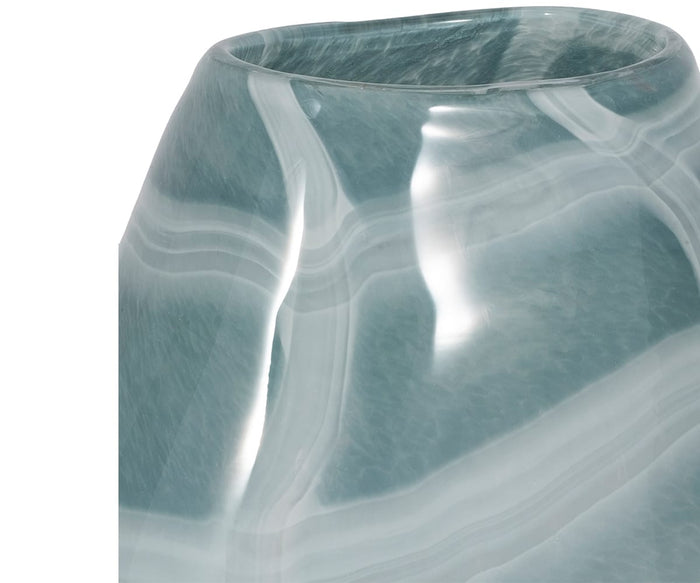 Close-up of the Sculpted Swirl Vase, a glossy hand-finished glass accent in blue-green with white marbled swirls and a slightly irregular, organic form.