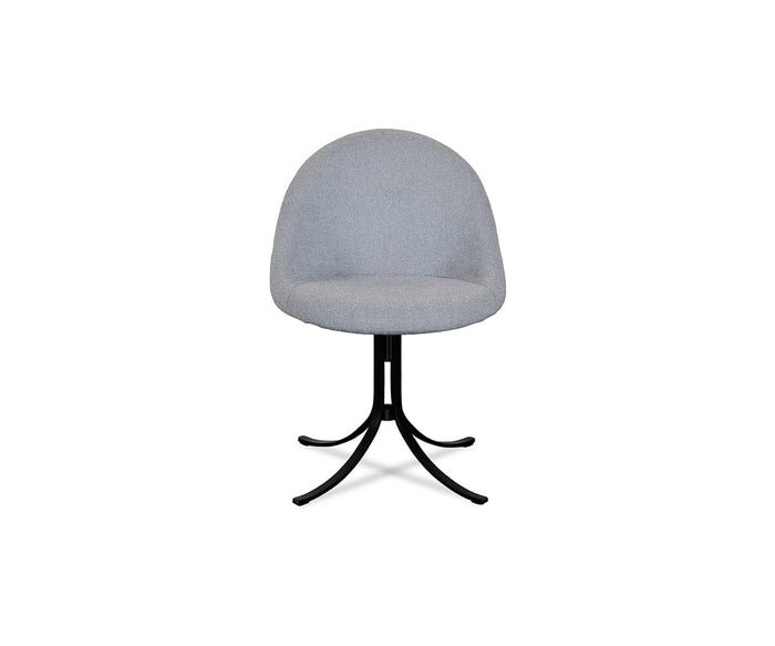 A modern, Selene blue upholstered chair, the Selene Dining Chair features a rounded backrest and seat supported by a black metal base with four curved legs, shown against a plain white background. This contemporary dining chair blends sleek style and comfort for any modern dining space.