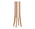 The Sendai Floor Lamp showcases a modern design with four elegantly curved wooden legs forming a striking base, finished in a light honey pine color. A tall, cylindrical fabric shade sits at the center, complementing the contemporary aesthetic.