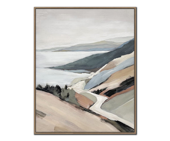 Framed abstract landscape paintings featuring winding paths leading toward serene bodies of water, flanked by rolling hills in muted tones of beige, grey, blue, and dark green beneath cloudy skies. The Shoreline Drive I & II Wall Art Set is beautifully rendered on textured canvas, adding depth and visual interest to your coastal wall art collection.