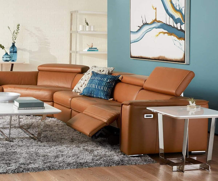 Modern living room featuring a brown leather sectional sofa with one seat reclined, a blue accent wall, abstract art, and the Sieva End Table with stainless steel legs. The space also includes a white high-gloss coffee table, shaggy gray rug, wood floors, and minimal decor.
